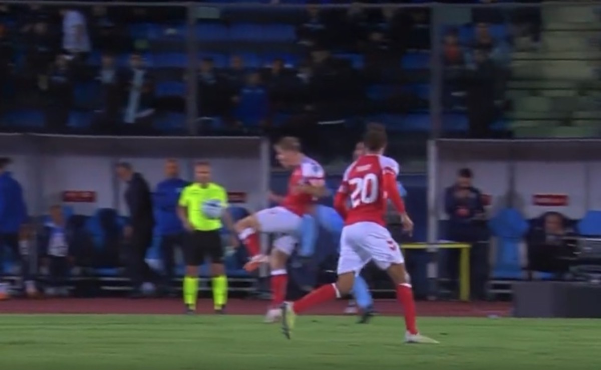 Rasmus Hojlund pictured being kneed in the back during Denmark's 2-1 win over San Marino in October 2023